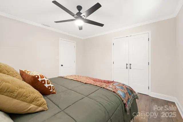 a bedroom with a bed and a chandelier