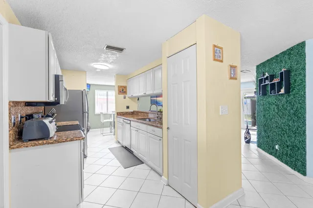 a kitchen with stainless steel appliances a refrigerator and a stove