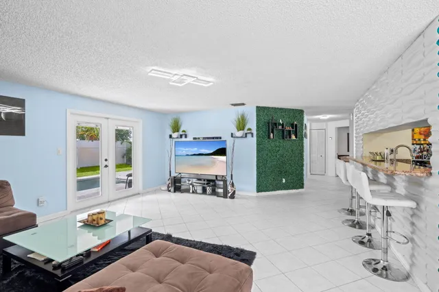 a living room with furniture and large window