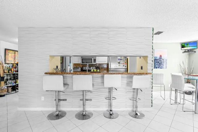 a living room with furniture and chairs