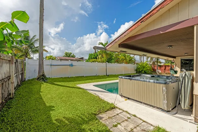 a view of a house with backyard sitting area and garden