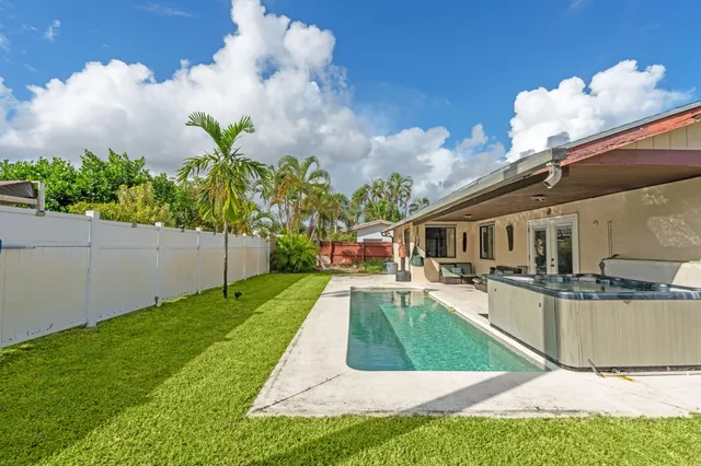 a view of a house with backyard porch and sitting area