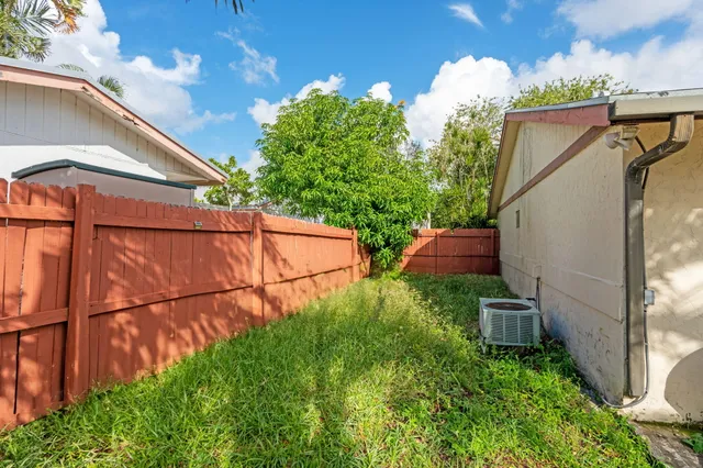 a view of a backyard with swimming pool