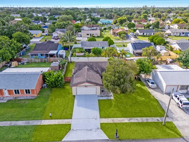 an aerial view of residential houses with outdoor space