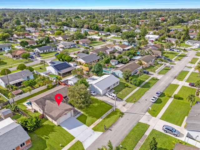 an aerial view of residential houses with outdoor space
