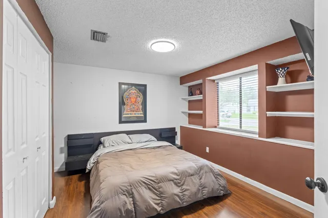 a bed sitting in a bedroom next to a window