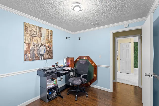 a view of a workspace with furniture and a window