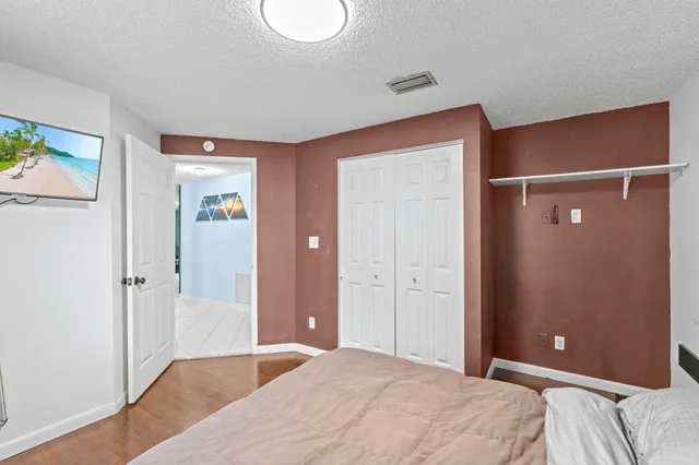 a bedroom with a bed and a mirror