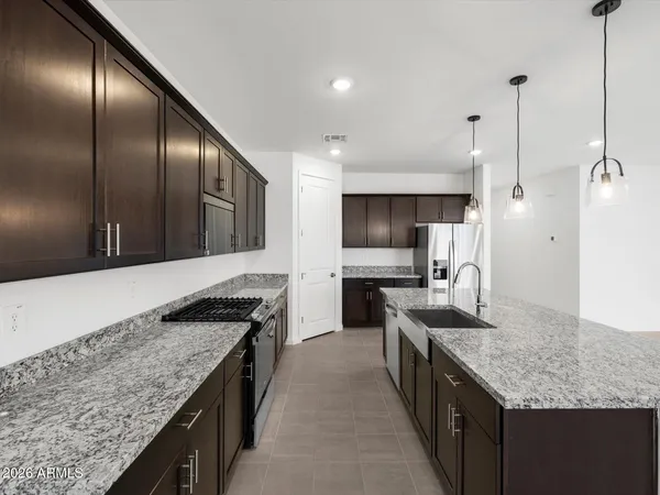 a kitchen with stainless steel appliances granite countertop a kitchen island a cabinets and wooden floor