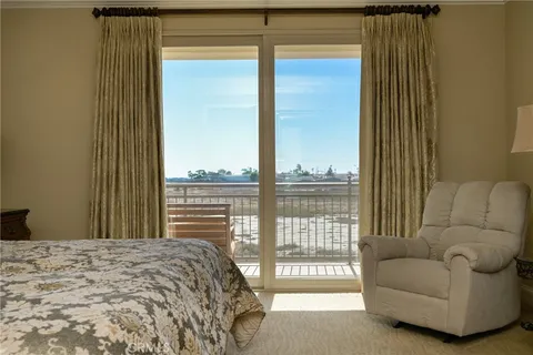 a bedroom with a bed and a balcony view