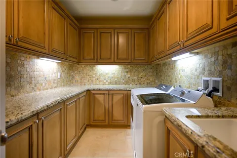 a kitchen with a sink a cabinets and appliances