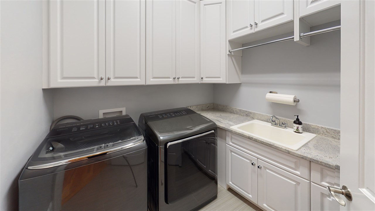 621 Manchester Drive Raleigh, NC 27609 - Photo 20 of 28 First floor laundry with custom cabinets, washout sink and granite countertops. Washer and dryer included First Floor Laundry