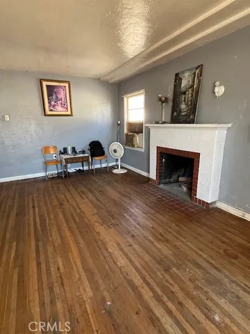 a view of a livingroom with furniture staircase and a fireplace