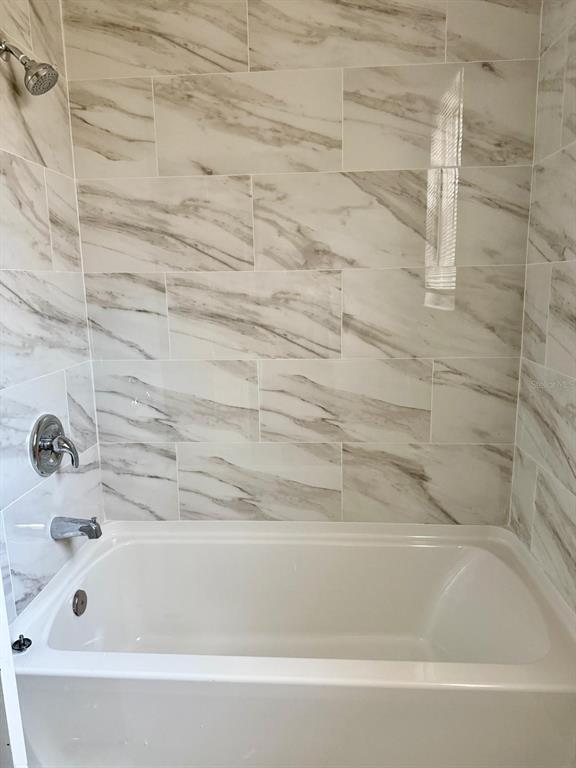 13572 Turtle Marsh Loop, Unit 212 Orlando, FL 32837 - Photo 11 of 20 a bathroom with a bathtub