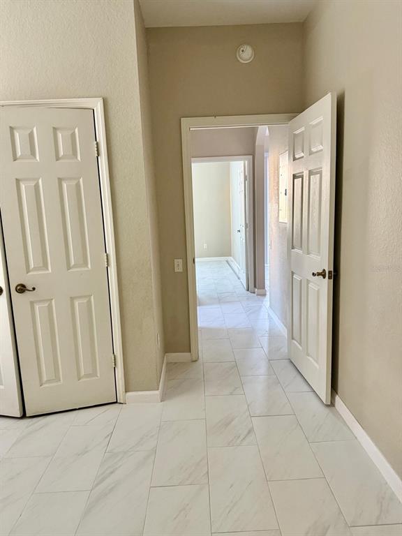 13572 Turtle Marsh Loop, Unit 212 Orlando, FL 32837 - Photo 15 of 20 a view of a livingroom with wooden floor and a hallway