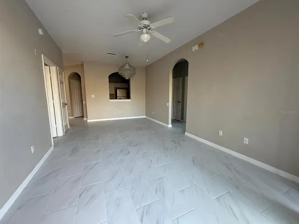 a kitchen with white cabinets and sink