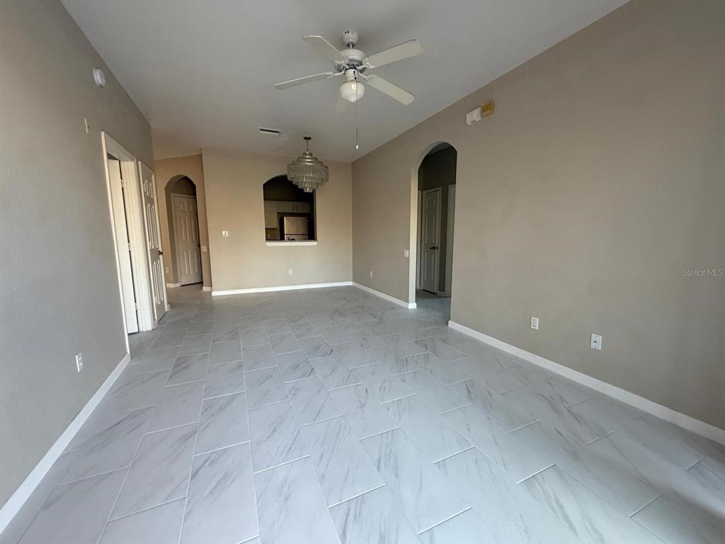 13572 Turtle Marsh Loop, Unit 212 Orlando, FL 32837 - Photo 4 of 20 wooden floor in an empty room with a window