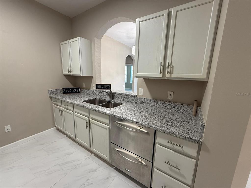 13572 Turtle Marsh Loop, Unit 212 Orlando, FL 32837 - Photo 6 of 20 a kitchen with white cabinets and sink