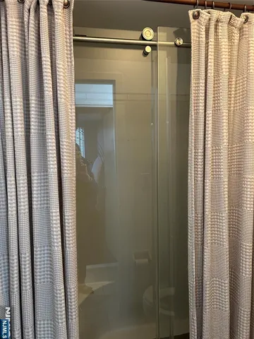 a bathroom with a shower and a glass door