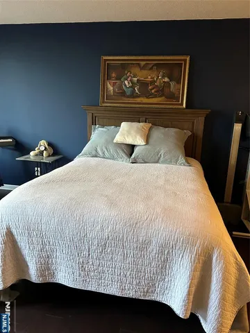 a bed sitting in a bedroom next to a wall