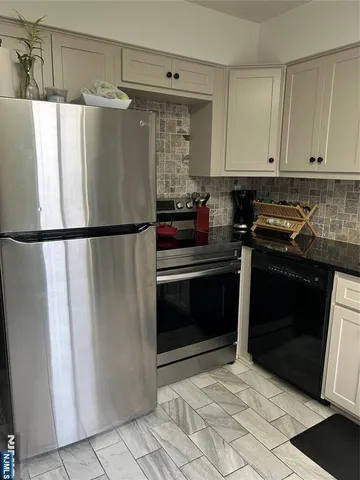 a kitchen with a refrigerator and a stove