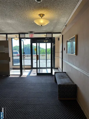 a spacious bedroom with a bed and a chandelier