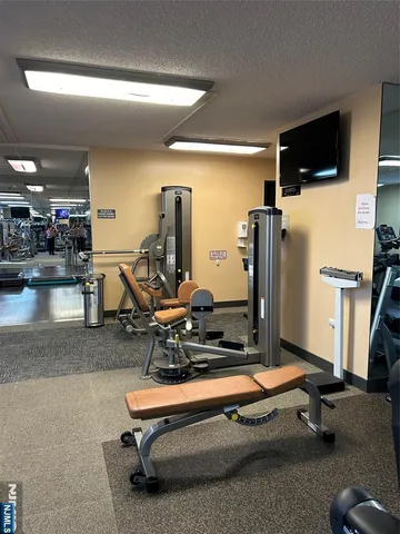 a room with gym equipment and a large window