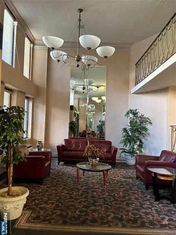 a living room with furniture and a chandelier