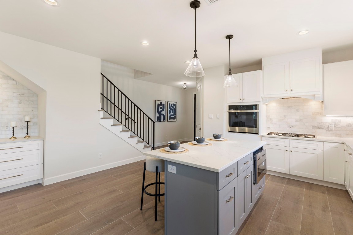 3223 Tamy Lane Brenham, TX 77833 - Photo 13 of 50 a kitchen with kitchen island a sink appliances and a floor