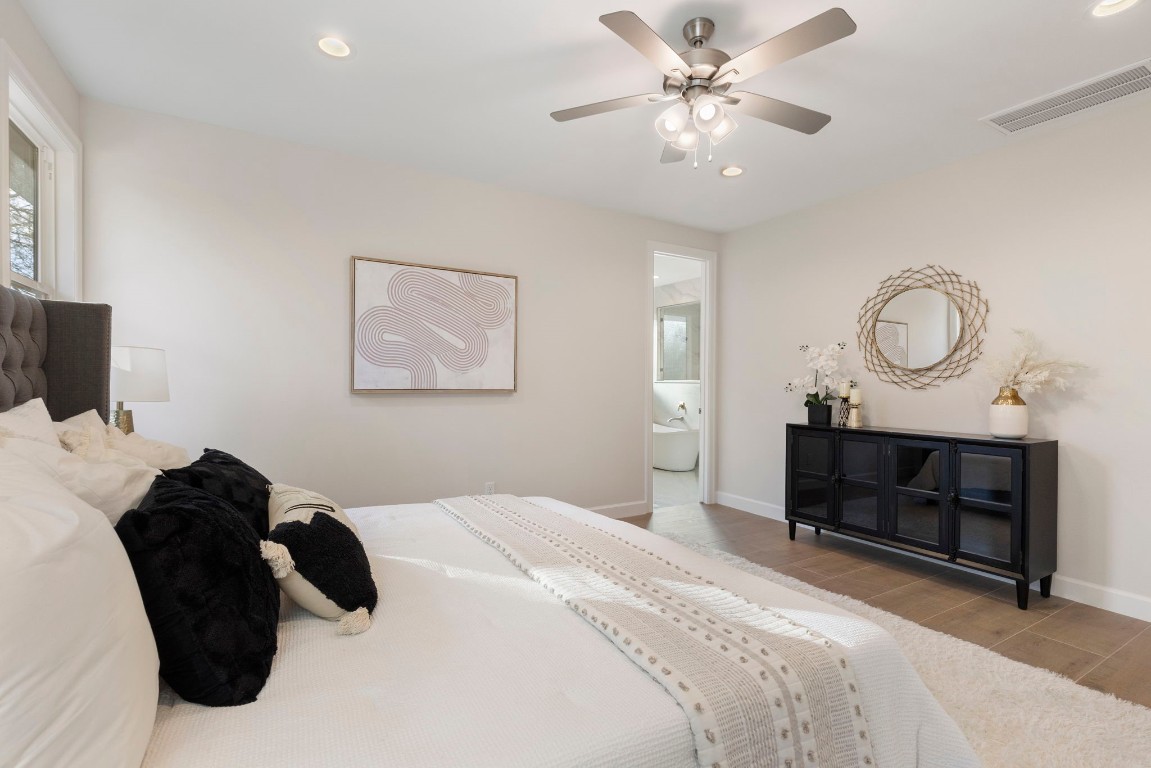 3223 Tamy Lane Brenham, TX 77833 - Photo 27 of 50 a bedroom with a bed and a chandelier