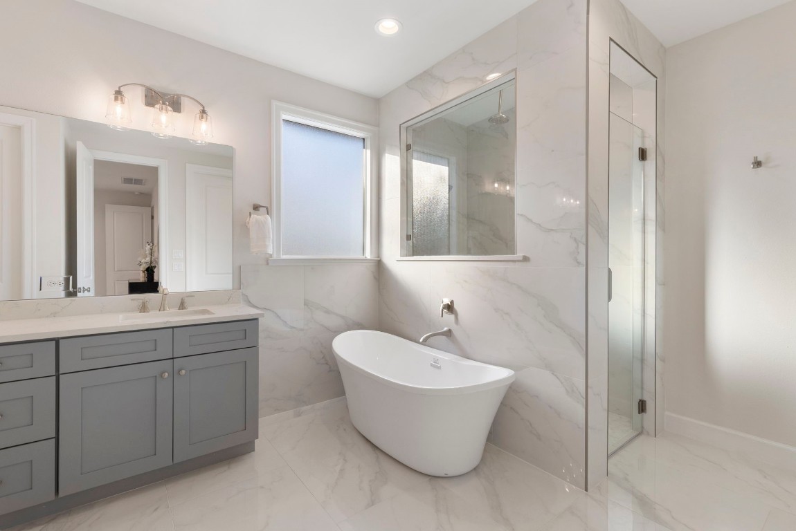 3223 Tamy Lane Brenham, TX 77833 - Photo 29 of 50 a bathroom with a white tub shower sink and mirror