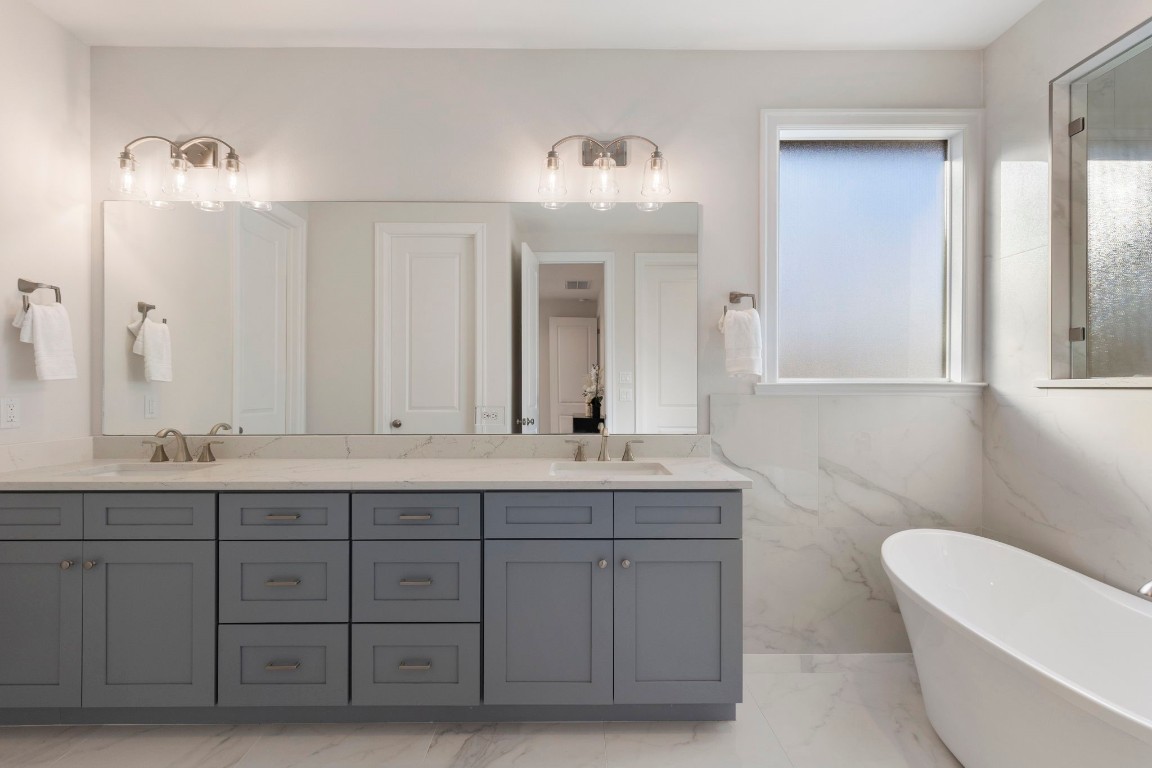 3223 Tamy Lane Brenham, TX 77833 - Photo 30 of 50 a bathroom with a double vanity sink a toilet and a mirror