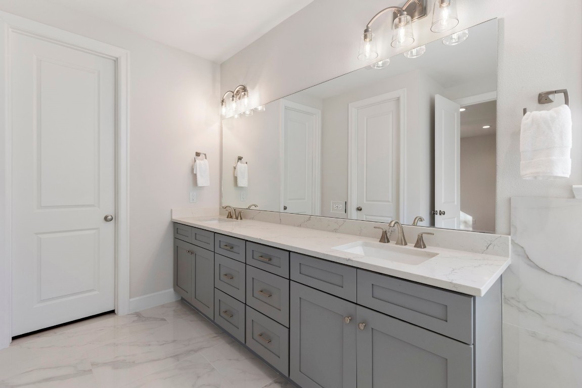 3223 Tamy Lane Brenham, TX 77833 - Photo 40 of 50 a bathroom with double sink and a mirror