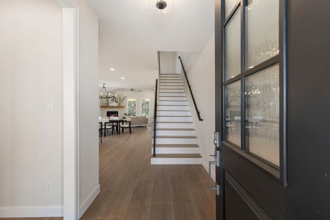 3223 Tamy Lane Brenham, TX 77833 - Photo 4 of 50 a hallway with wooden floor furniture and entryway