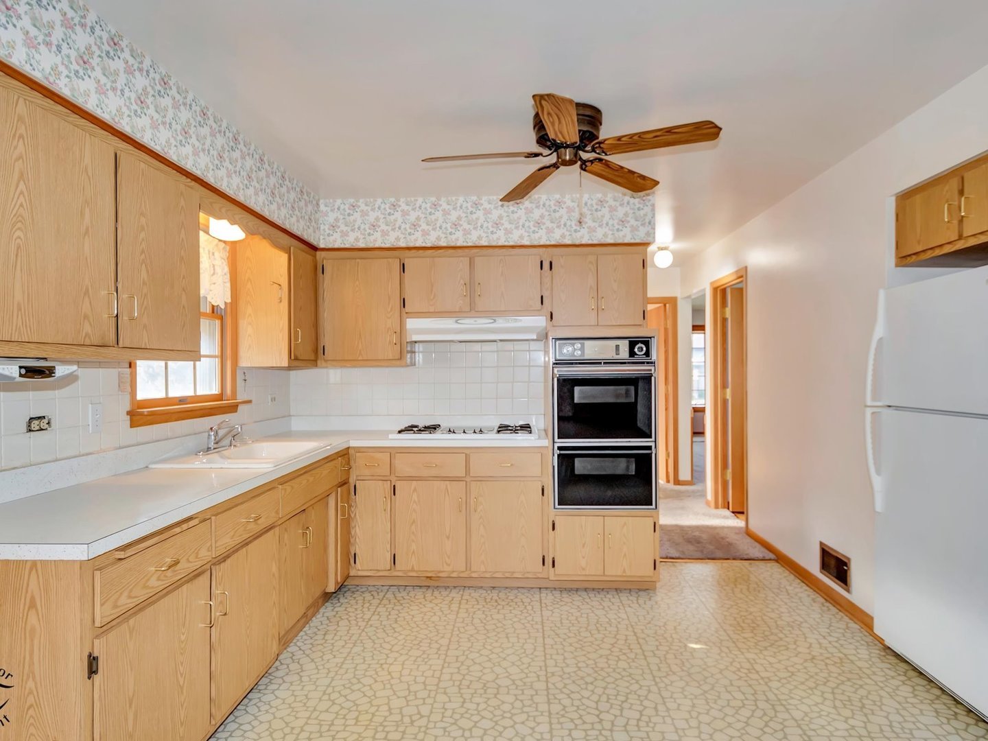 15043 Tripp Avenue Midlothian, IL 60445 - Photo 4 of 16 a kitchen with stainless steel appliances a stove a sink and a refrigerator