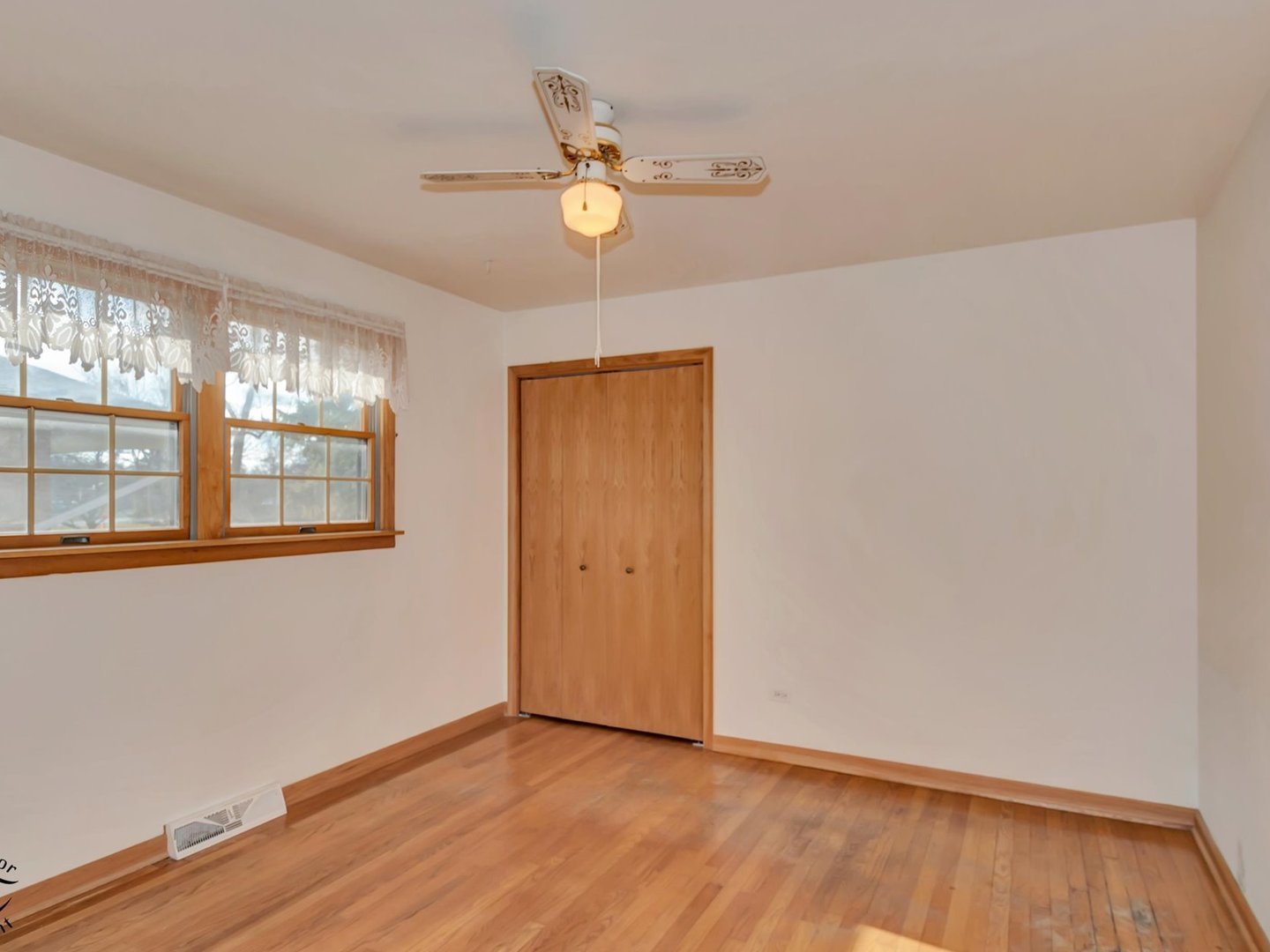 15043 Tripp Avenue Midlothian, IL 60445 - Photo 7 of 16 a view of an empty room with wooden floor and a window