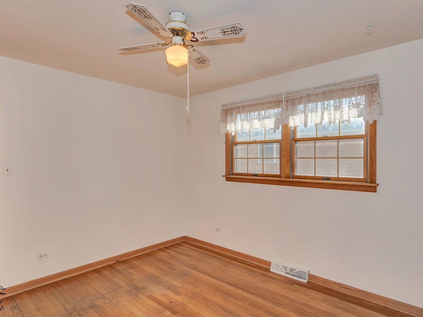 15043 Tripp Avenue Midlothian, IL 60445 - Photo 8 of 16 wooden floor in an empty room with a window