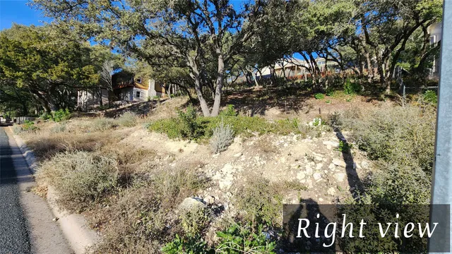 a view of a tree is standing in between of the house