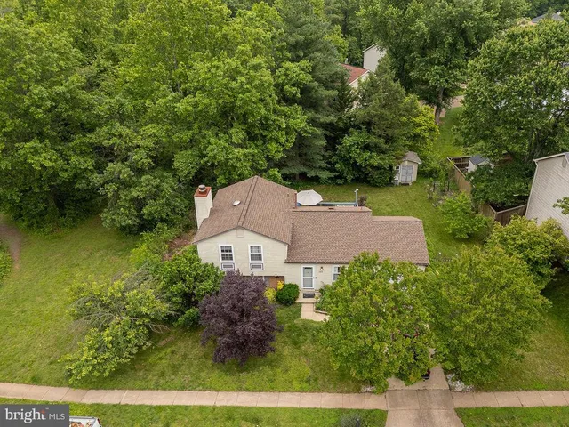 an aerial view of a house with garden space and outdoor seating
