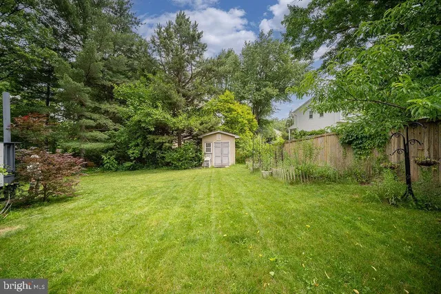 a backyard of a house with lots of green space and plants