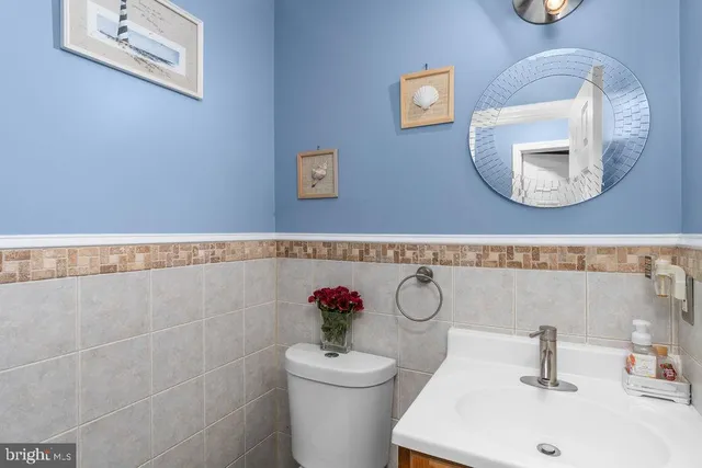 a bathroom with a toilet a sink and mirror
