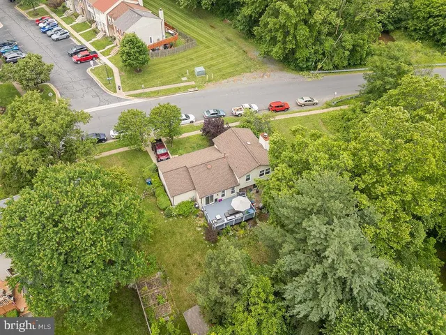 an aerial view of residential house with an outdoor space and seating