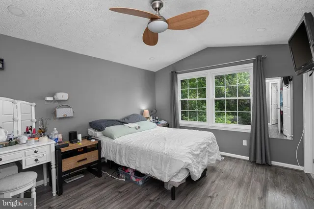 a bedroom with a bed and a large window