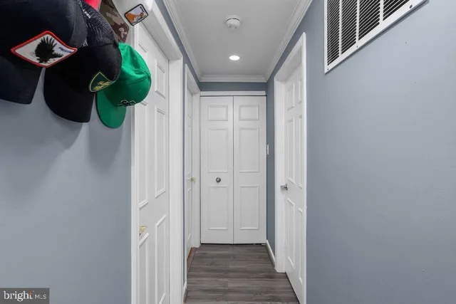 a view of a hallway to front door with wooden floor