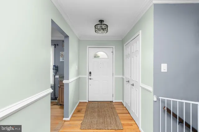 a view of a hallway view with wooden floor and a bathroom