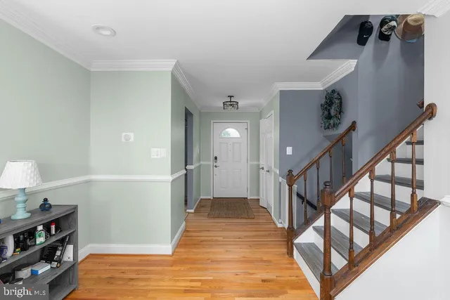 a view of entryway and hall with wooden floor