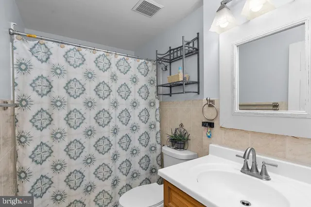 a bathroom with a sink toilet and mirror