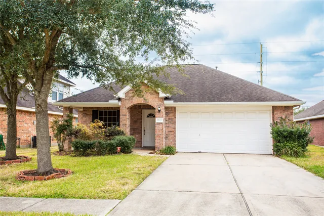 a front view of house with yard and trees around