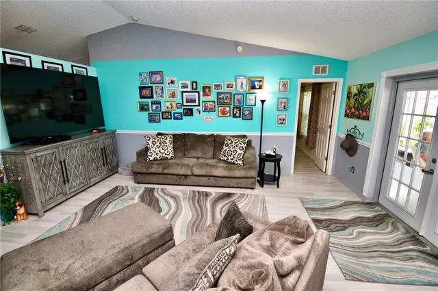 a living room with furniture and a bookshelf