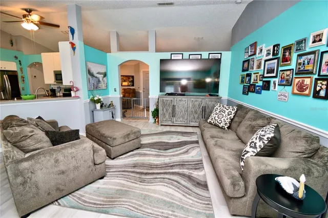a kitchen that has a microwave a stove and white cabinets